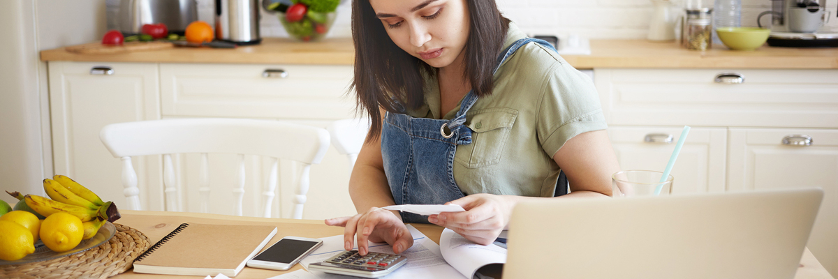 Girl with paper calculating payment